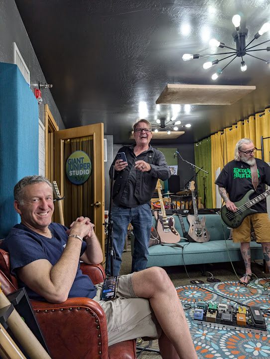 A band gathered in the tracking room during a session