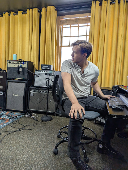 A guitarist tracking through a pedalboard