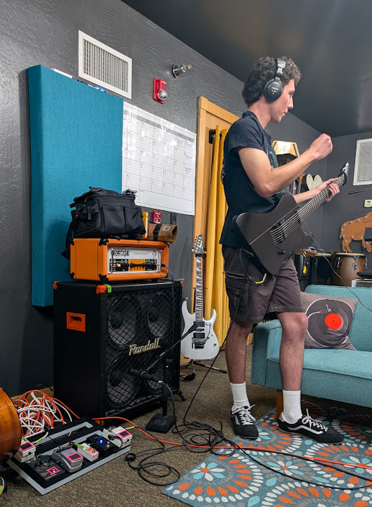 A musician listening back during a recording session
