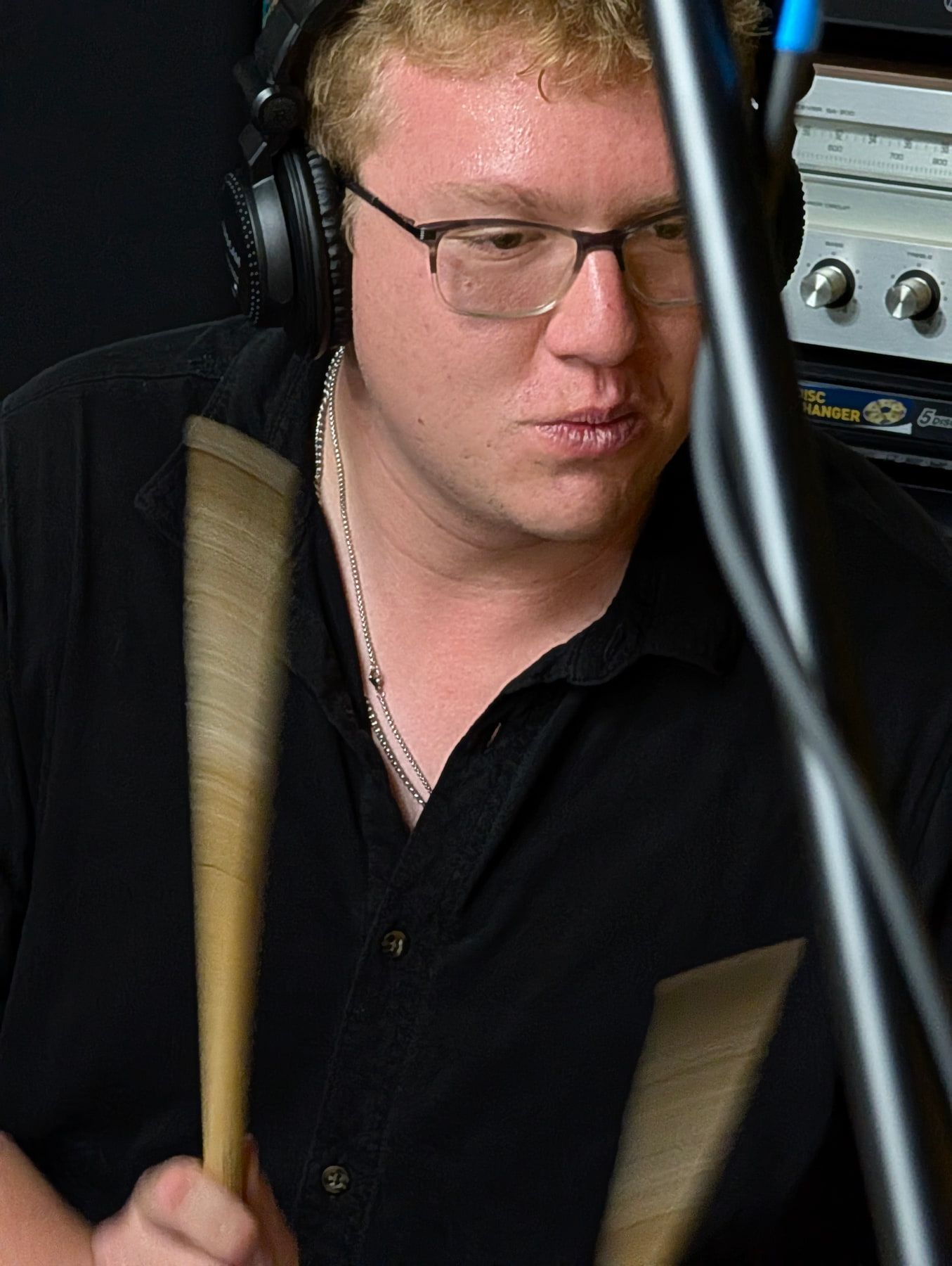 A drummer tracking a close-miked performance