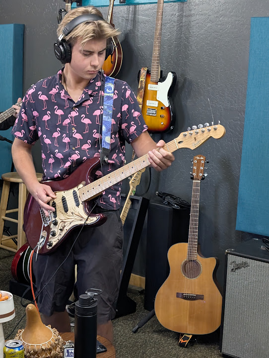 A guitarist recording a part at Giant Juniper Studio