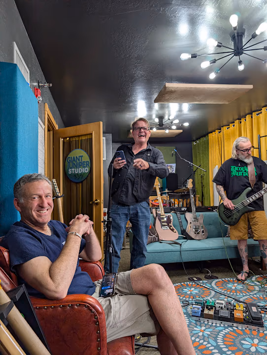 A band gathered in the tracking room during a session
