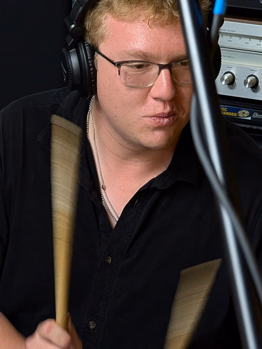 A drummer tracking a close-miked performance