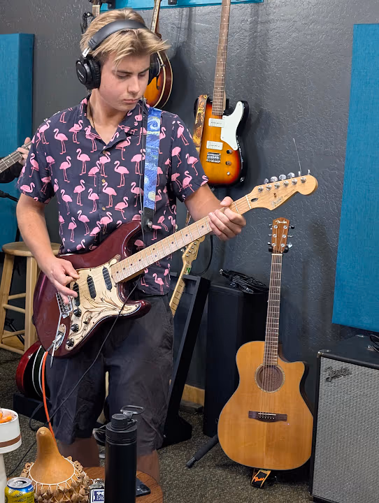 A guitarist recording a part at Giant Juniper Studio
